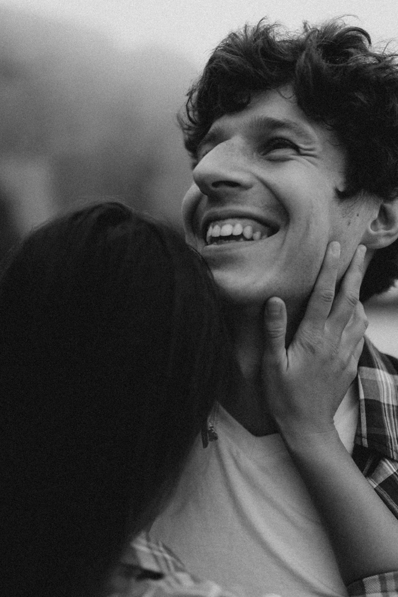 Couple embracing with an intimate smile, black and white portrait